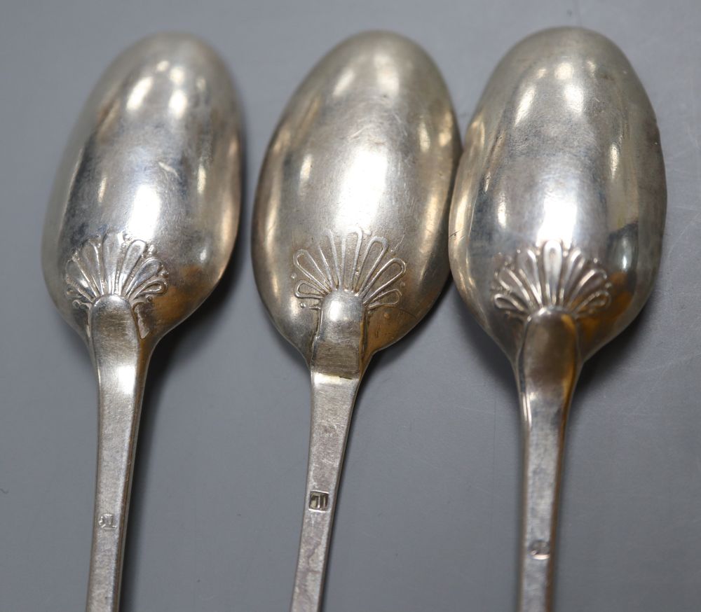 An 18th century Jersey silver table spoons, makers mark for Pierre Amiraux, 19.5cm and three 18th century shell back teaspoons